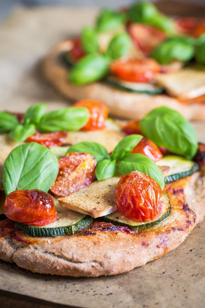 Vegan Pizza - exceptionally light pizza base topped with garlic, cherry tomatoes, garlic, basil and vegan camembert | thecookandhim.com