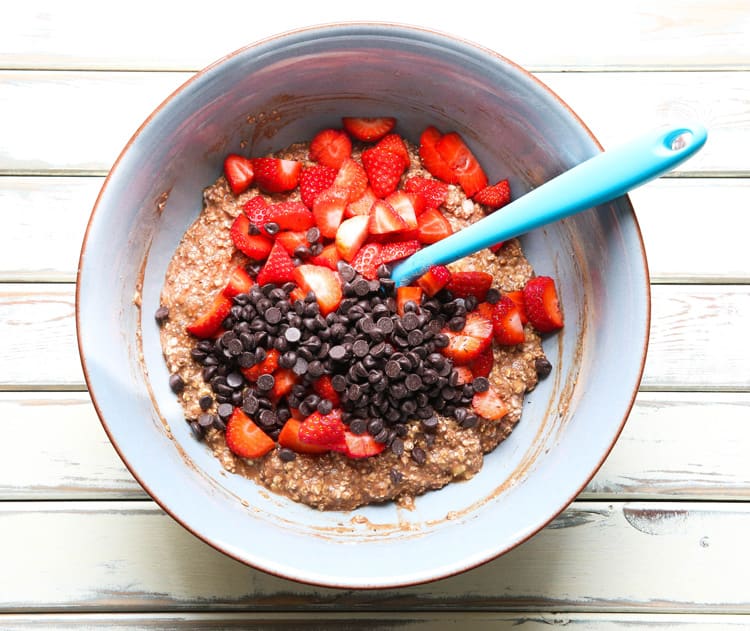 Adding strawberries and chocolate chips to the Baked Acai & Strawberry Oats | thecookandhim.com