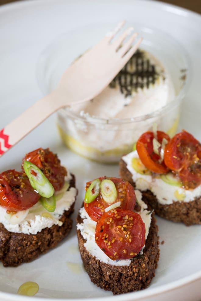 Cherry Tomato and Goat's Cheese Crostini - just a few simple ingredients make these salty, nutty bites sheer indulgent heaven. The New Roots goat's cheese makes them vegan too! thecookandhim.com