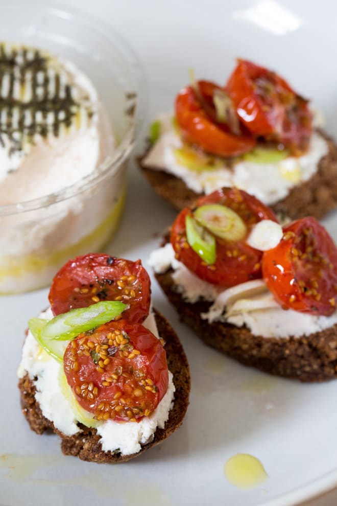 Cherry Tomato and Goat's Cheese Crostini - just a few simple ingredients make these salty, nutty bites sheer indulgent heaven. The New Roots goat's cheese makes them vegan too! thecookandhim.com