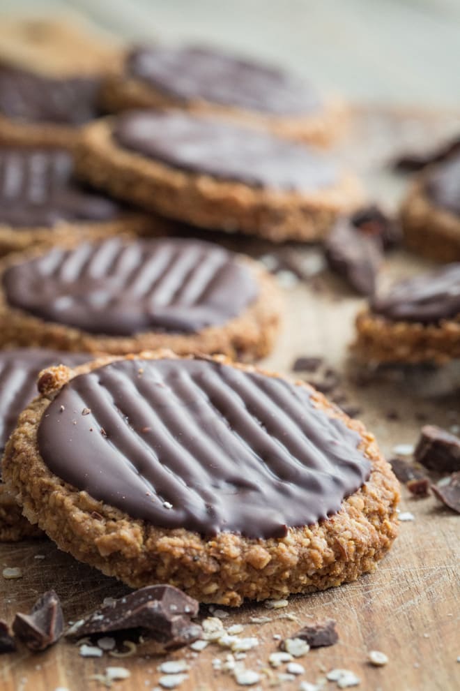 Thick, chewy, oaty biscuits slathered in dark chocolate, these digestive biscuits are for people who take their biscuits seriously! They're also vegan, gluten free, really easy to make and perfect with a cuppa #glutenfree #digestivebiscuits #homemadebiscuits #veganbiscuits