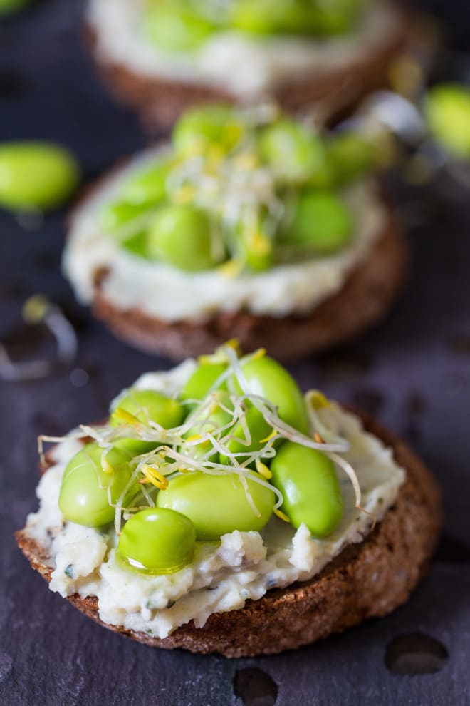 Crostini with Fava Beans, Mint and Ricotta - perfect little party nibbles or a tasty lunchtime snack! Nutrient packed fava beans combine with creamy ricotta and fresh mint | thecookandhim.com