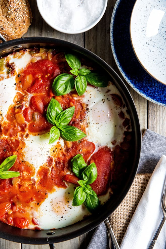 Fava Bean Shakshuka - a bright, lightly spiced hearty meal perfect for any time of the day! Full of tomatoes, herbs, garlic, peppers, onions and spices all made in just one pan! #vegetarian #meatfree #shakshuka | thecookandhim.com