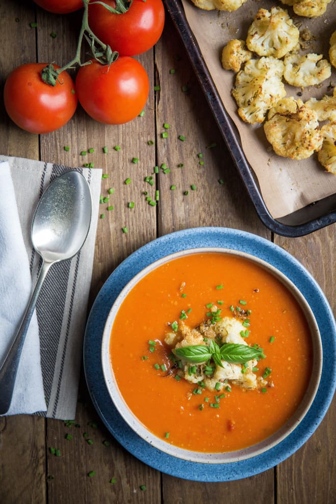 Red Pepper and Tomato Soup with Roasted Cauliflower - nothing but veggies, fruit (yep fruit!) and spices go into this deliciously rich and hearty soup that's so simple to make! Vegan and Gluten Free | thecookandhim.com