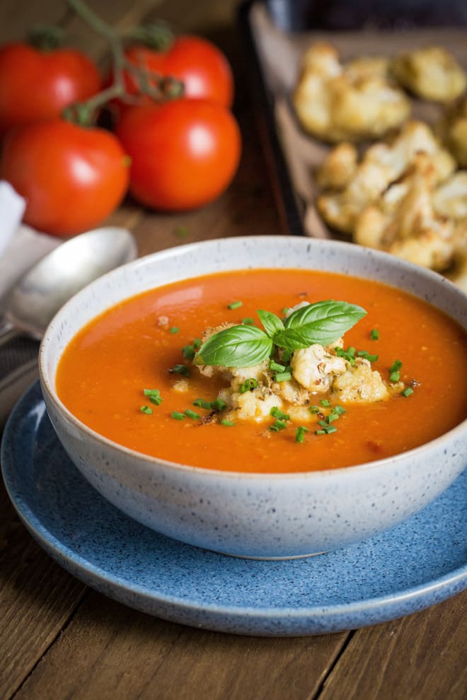 Red Pepper and Tomato Soup with Roasted Cauliflower - nothing but veggies, fruit (yep fruit!) and spices go into this deliciously rich and hearty soup that's so simple to make! Vegan and Gluten Free | thecookandhim.com