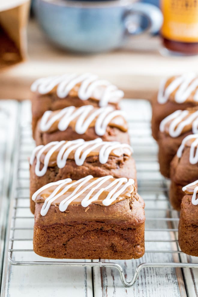 Cappuccino Mini Loaves - light and moist coffee sponge topped with a divinely sweet coffee and vanilla frosting. These vegan mini loaves are incredibly moreish! #vegan #veganbaking #coffeecake | Recipe on thecookandhim.com