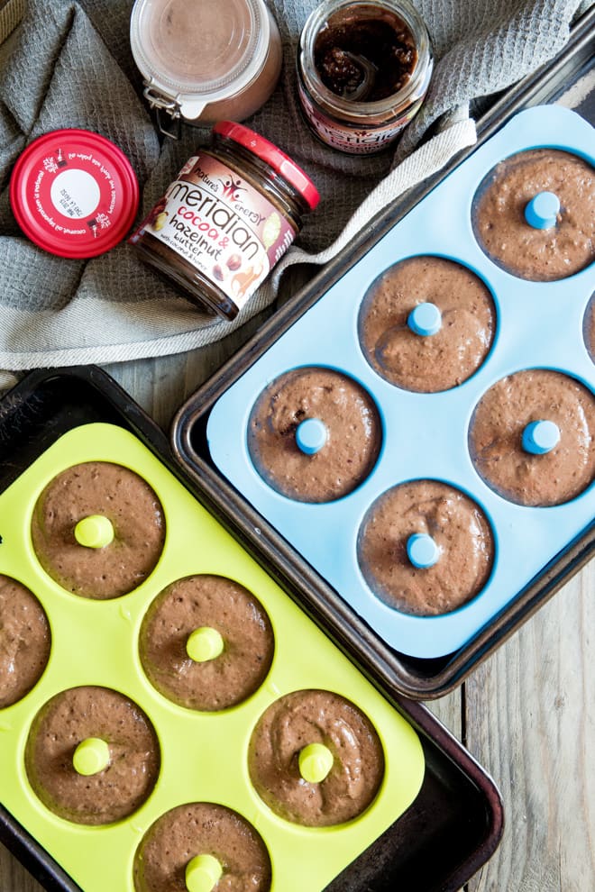 Chocolate Hazelnut Donuts - deliciously moist, light and fluffy baked donuts with smooth cocoa and hazelnut butter and a rich dark chocolate topping! #donuts #bakeddonuts #doughnuts | Recipe on thecookandhim.com