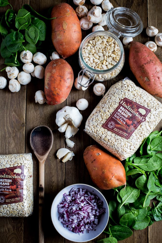 Garlic Mushroom Stuffed Sweet Potatoes - creamy fava beans, herbs, spices and aromatic garlic mushrooms are all crammed into crisp baked sweet jacket potatoes #meatfree #vegan #veganprotein | Recipe on thecookandhim.com