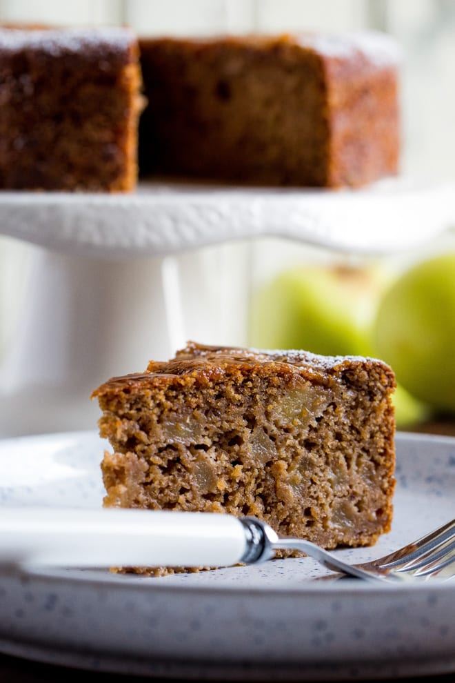 This easy spiced vegan apple cake is a rich but light brown sugar sponge brimming with soft apples and warming spices. It makes a perfect autumn dessert or a lovely afternoon treat with a cuppa! Recipe on thecookandhim.com | #vegancake #applecake #veganapplecake #autumnrecipes #fallrecipes