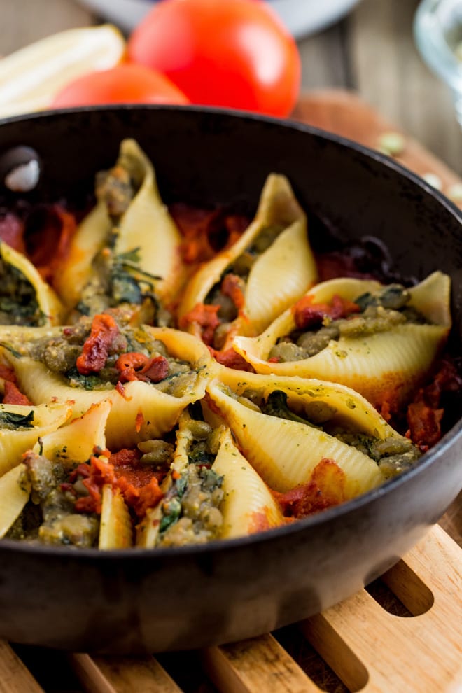 Green Split Pea and Pesto Stuffed Conchiglie - soft pasta shells filled with split peas and homemade pesto, baked in a tangy tomato sauce. All vegan and all delicious! #veganpastarecipe #veganrecipes #pastarecipes | Recipe on thecookandhim.com