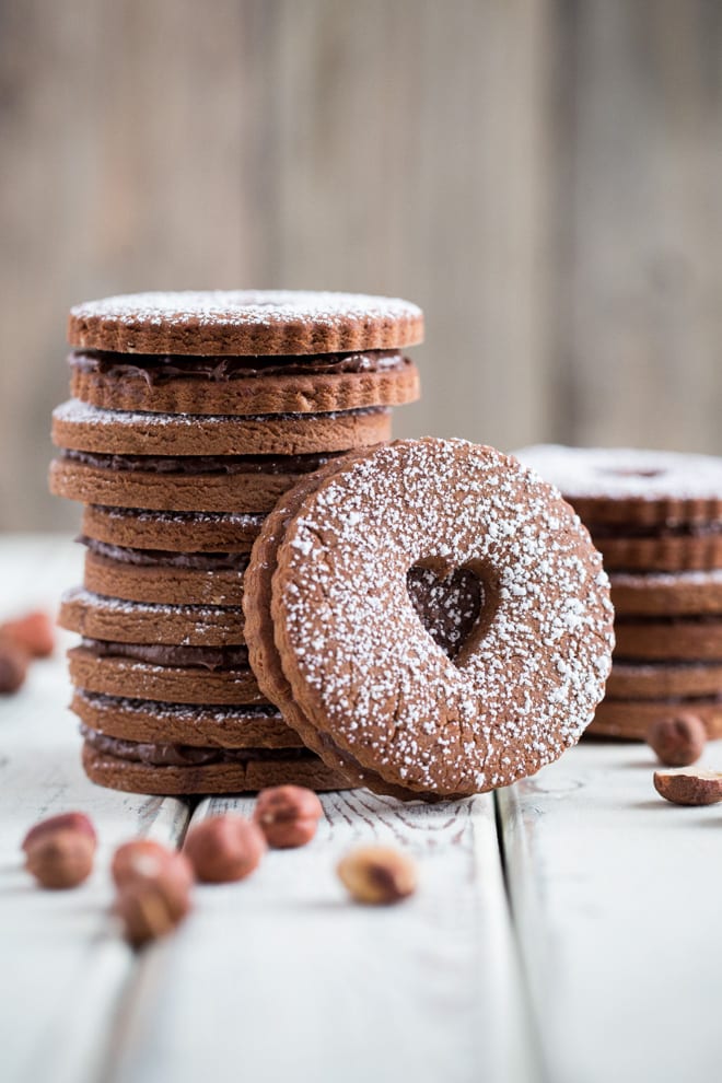 Hazelnutter Cookies - rich milk chocolate flavoured shortbread cookies with just 5 ingredients. Sandwiched with smooth chocolate protein spread | Recipe on thecookandhim.com