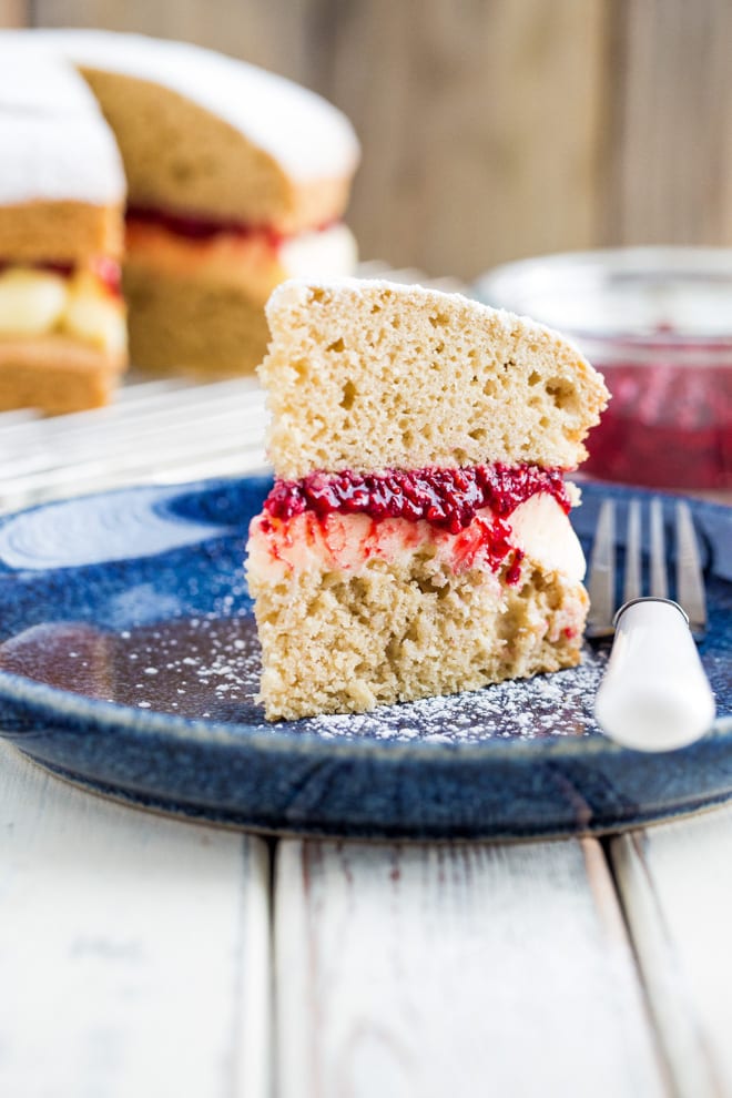 Vegan Cake - a deliciously light vegan version of a classic Victoria Sponge Cake with vegan sweet vanilla frosting and homemade raspberry jam #vegancake #veganbaking | Recipe on thecookandhim.com