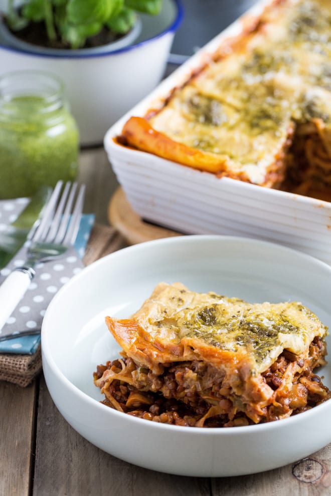 Vegetarian Lasagne Recipe - packed with veggies and lentils in a rich tomato sauce, layered and topped with a vegan cheese and pesto sauce #vegetarianlasagne #vegetablelasagne #veglasagnerecipe #veganrecipes | Recipe on thecookandhim.com