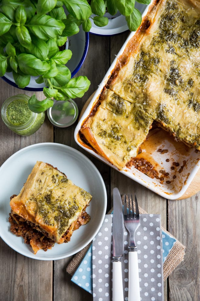 Vegetarian Lasagne Recipe - packed with veggies and lentils in a rich tomato sauce, layered and topped with a vegan cheese and pesto sauce #vegetarianlasagne #vegetablelasagne #veglasagnerecipe #veganrecipes | Recipe on thecookandhim.com