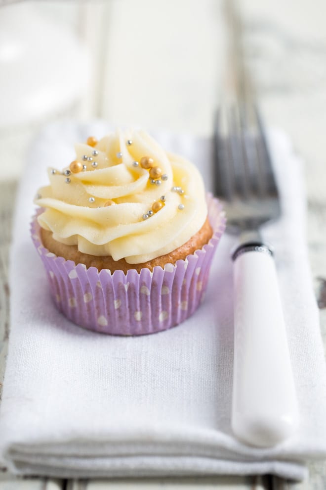 Easy Vegan Vanilla Cupcakes - just a few, basic ingredients needed for these delicate little sponges topped with sweet and creamy vegan frosting! #vegancupcakes #veganbaking #veganfrosting #vanillacupakes | Recipe on thecookandhim.com