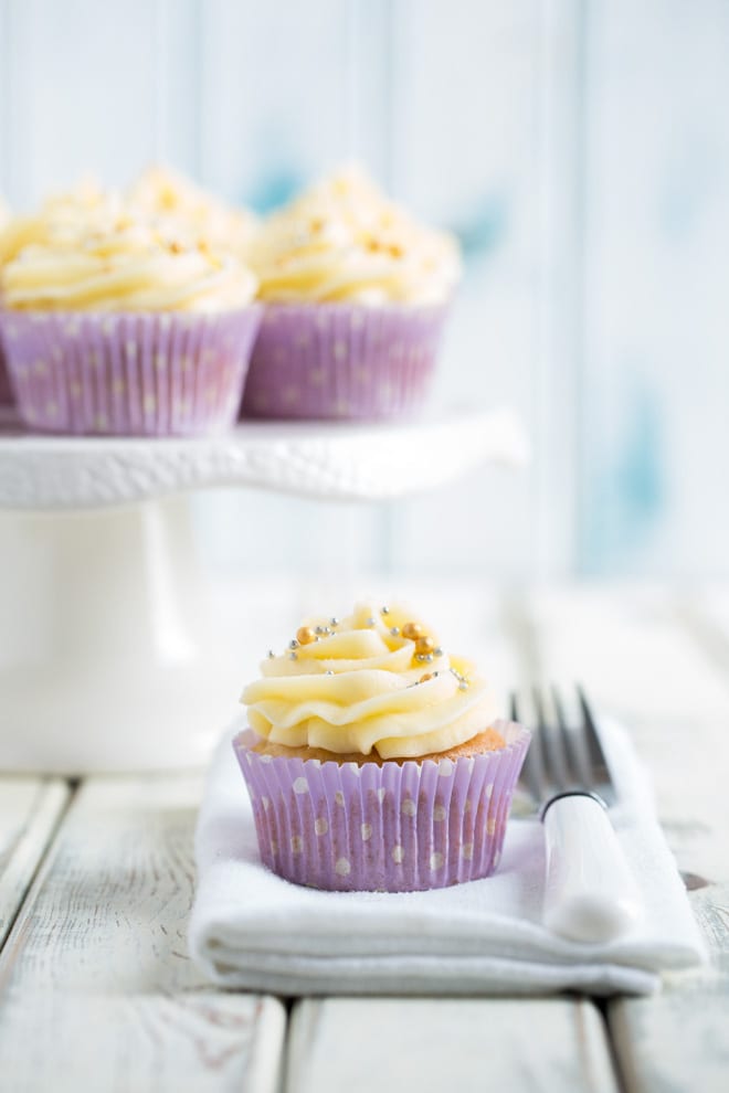 Easy Vegan Vanilla Cupcakes - just a few, basic ingredients needed for these delicate little sponges topped with sweet and creamy vegan frosting! #vegancupcakes #veganbaking #veganfrosting #vanillacupakes | Recipe on thecookandhim.com