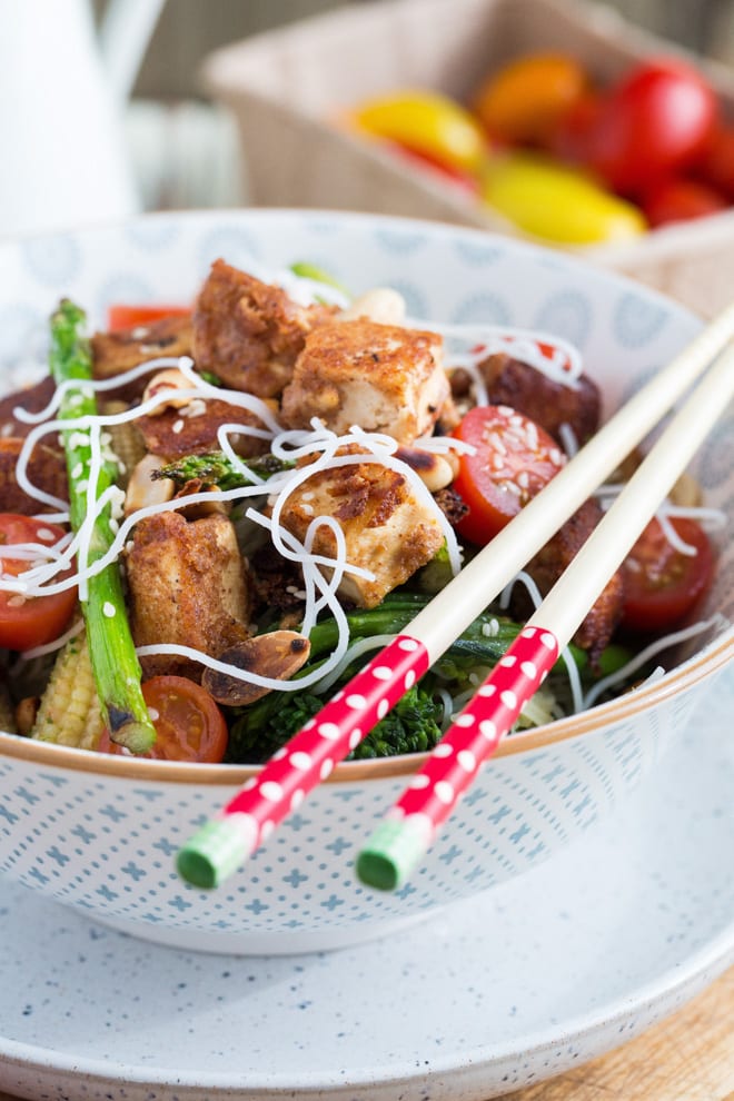 Tofu Stir Fry - crisp tofu marinated in a peanut stir fry sauce with fresh stir fry vegetables and rice noodles! #tofustirfry #cripsytofu #tofurecipes #veganrecipes | Recipe on thecookandhim.com