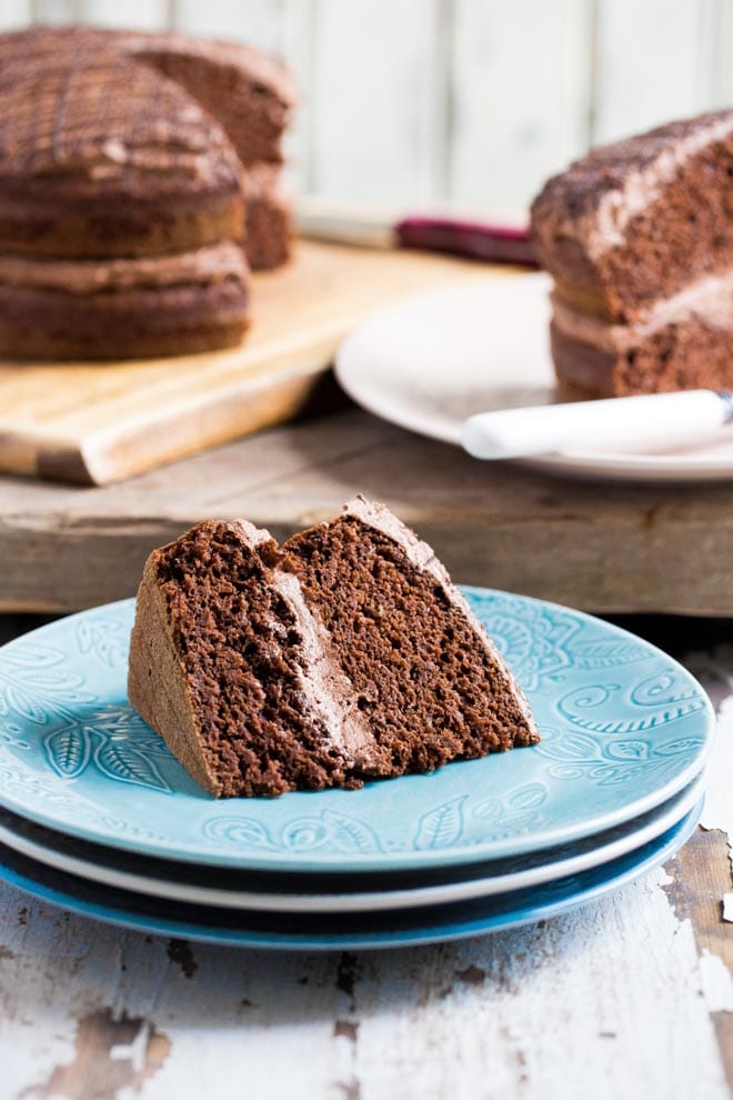 The yummiest Vegan Chocolate Fudge Cake, rich but light and divinely chocolatey with a creamy and fluffy vegan chocolate frosting #vegancake #veganchocolatecake #chocolatefudgecake #veganbaking | Recipe on thecookandhim.com
