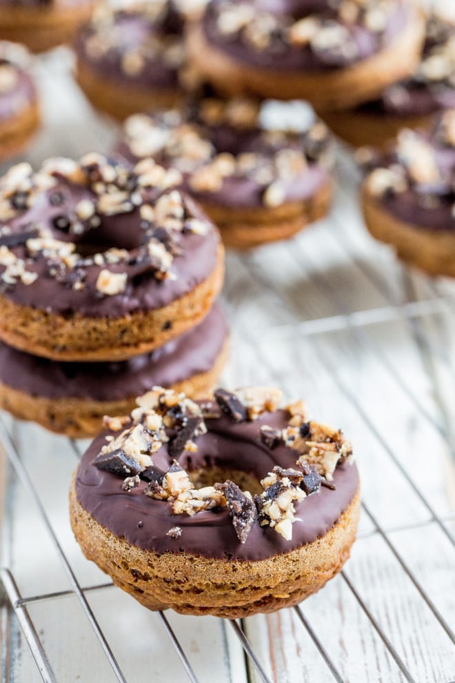 Go Nuts Donuts - Baked vegan donuts dipped in chocolate, topped with crumbled Grenade Go Nuts bars - full of vegan protein and delicious rich flavours! #vegandonuts #veganbaking #veganrecipes #veganprotein | Recipe on thecookandhim.com