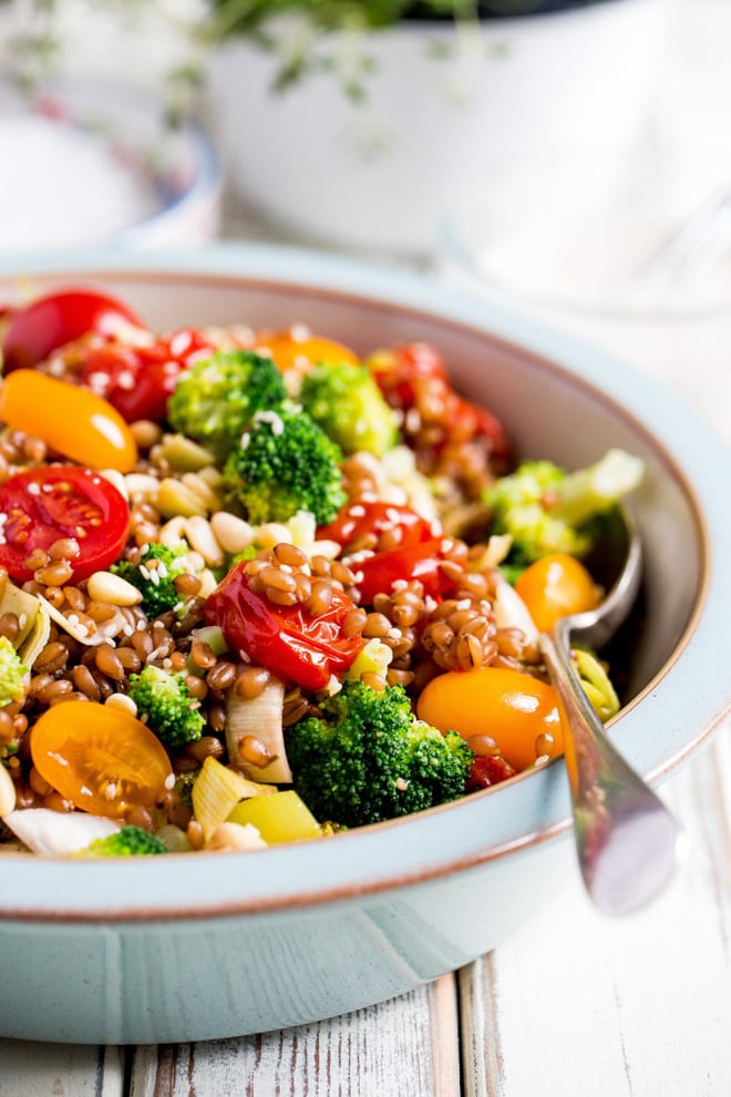 Wheat Berry Summer Salad - plump little wheat berries mixed with tonnes of veggies, herbs and a creamy lemon, garlic and tahini dressing #salad #saladdressing #summerrecipes #healthysalad | Recipe on thecookandhim.com