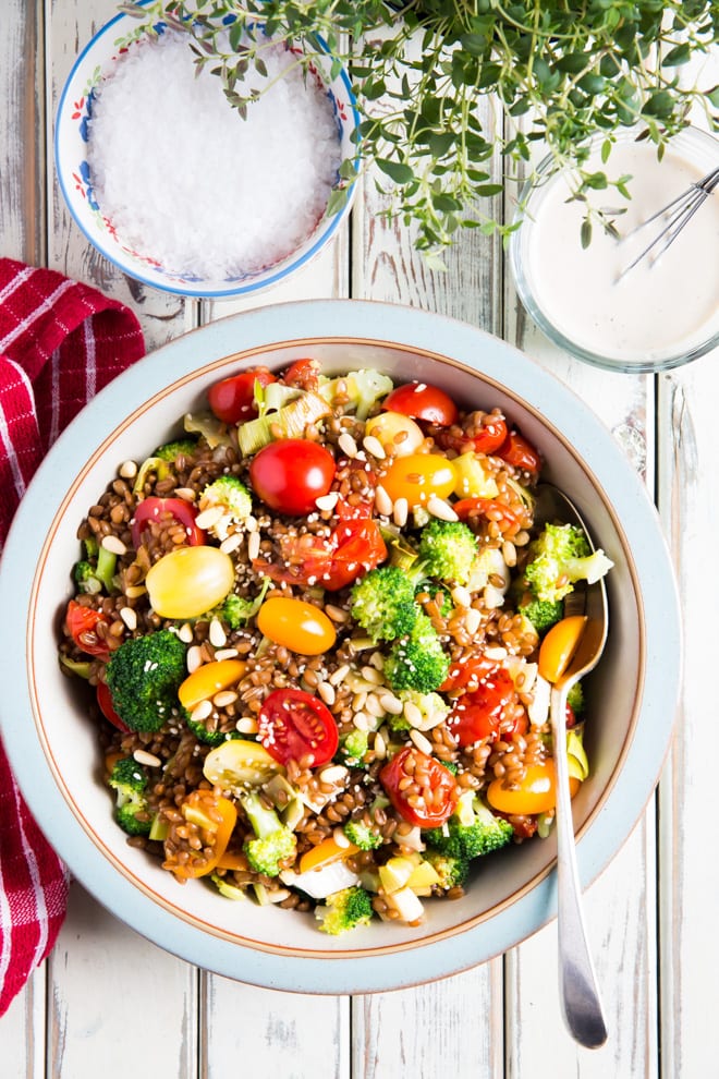 Wheat Berry Summer Salad - plump little wheat berries mixed with tonnes of veggies, herbs and a creamy lemon, garlic and tahini dressing #salad #saladdressing #summerrecipes #healthysalad | Recipe on thecookandhim.com