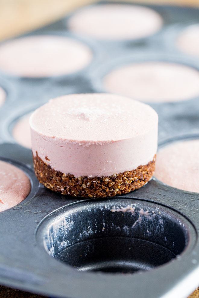Raw, vegan and gluten free these mini strawberry cheesecakes with a nut and chocolate base are smooth, creamy and so easy to make! #vegandesserts #vegancheesecake #rawvegan #glutenfree | Recipe on thecookandhim.com