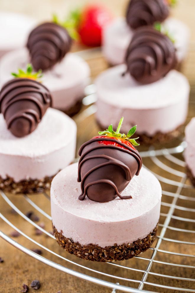 Raw, vegan and gluten free these mini strawberry cheesecakes with a nut and chocolate base are smooth, creamy and so easy to make! #vegandesserts #vegancheesecake #rawvegan #glutenfree | Recipe on thecookandhim.com