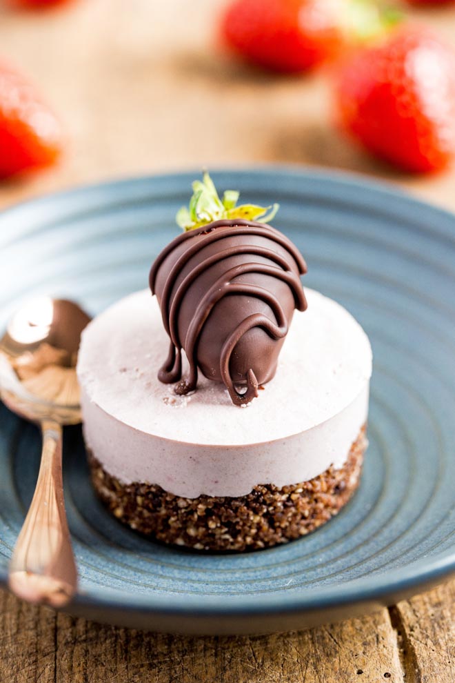 Raw, vegan and gluten free these mini strawberry cheesecakes with a nut and chocolate base are smooth, creamy and so easy to make! #vegandesserts #vegancheesecake #rawvegan #glutenfree | Recipe on thecookandhim.com