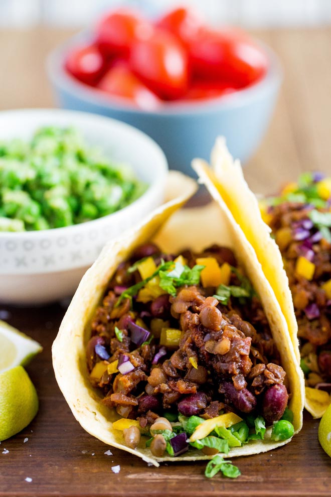 All the smoky flavours of a super easy home made BBQ sauce are infused into these vegan Bean and Lentil Tacos! #vegantacos #veganrecipes #bbq #haricotbeans #lentils #tacos | Recipe on thecookandhim.com