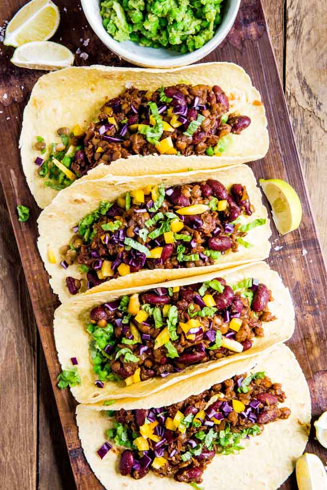 All the smoky flavours of a super easy home made BBQ sauce are infused into these vegan Bean and Lentil Tacos! #vegantacos #veganrecipes #bbq #haricotbeans #lentils #tacos | Recipe on thecookandhim.com