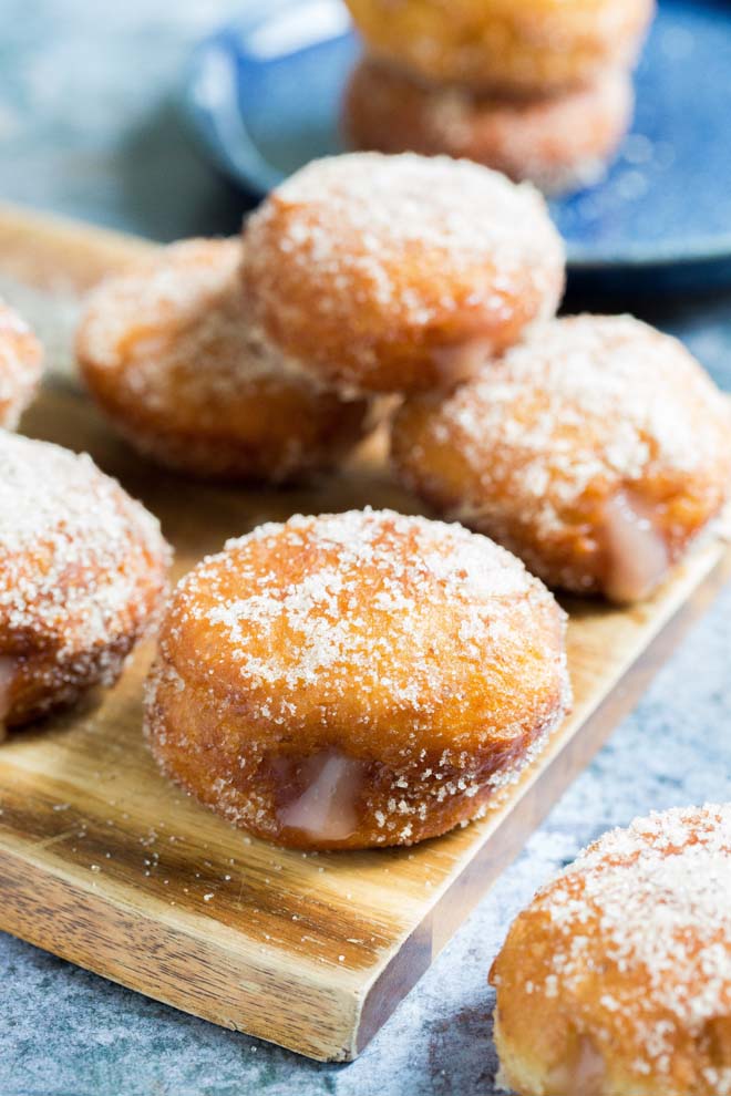 Fried vegan donuts with a crisp, sugary outside and soft fluffy centre with a divinely sweet grapefruit curd filling #frieddonuts #vegandonuts #donutrecipe #veganrecipes #grapefruit | Recipe on thecookandhim.com