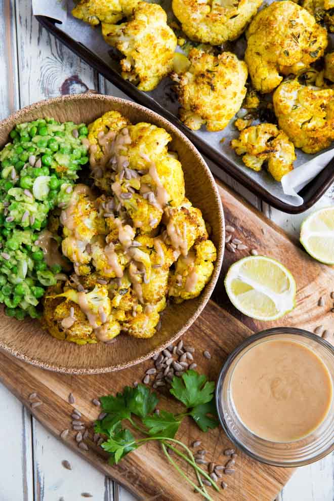 Gently spiced cauliflower cooked to crispy perfection! Drizzled with a smooth creamy tahini dressing this roasted cauliflower is easy and SO delicious! Perfect as a side dish, for packed lunches and picnics or even as a healthy snack! #roastedcauliflower #cauliflowerrecipes #veganrecipes #plantbased