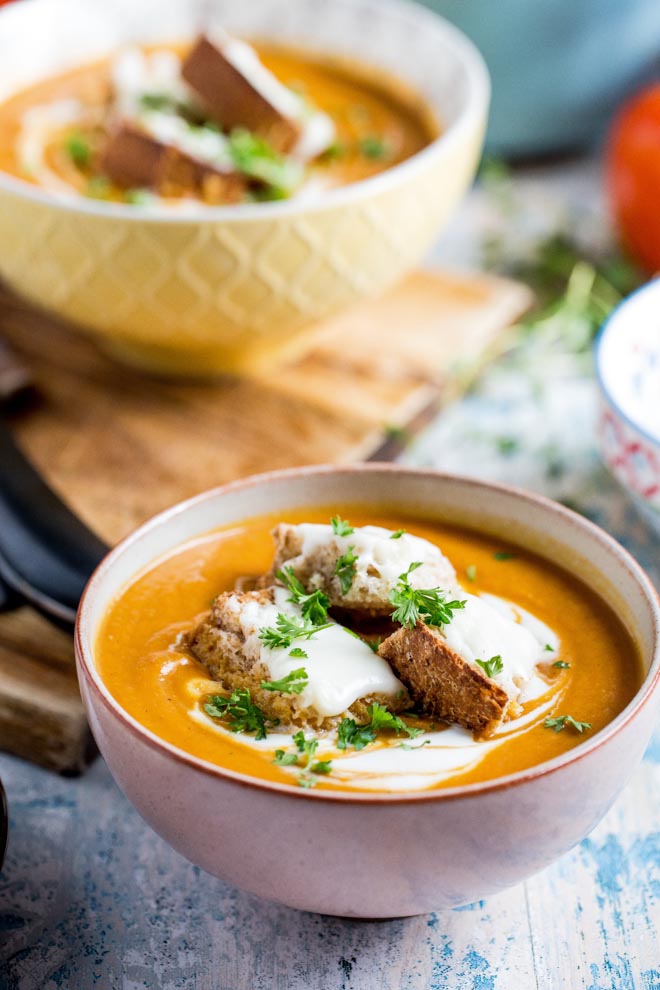 Thick, rich and delicious roasted tomato soup! Packed full of (hidden) roasted veggie flavour and so simple to make - even the vegan cheesy croutons! #tomatosoup #tomatosouprecipe #veganrecipes #vegansoup | Recipe on thecookandhim.com