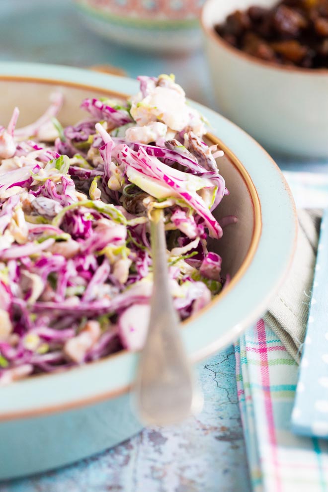 Creamy vegan winter slaw made with red cabbage, Brussels sprouts, red onion, crunchy walnuts, jewel like sultanas and a homemade vegan mustard mayonnaise! #veganrecipes #coleslaw #winterslaw #veganmayonnaise #veganmayo | Recipe on thecookandhim.com