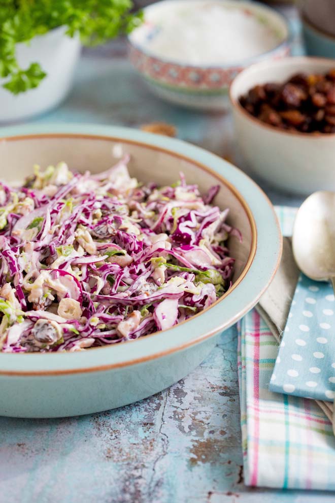 Creamy vegan winter slaw made with red cabbage, Brussels sprouts, red onion, crunchy walnuts, jewel like sultanas and a homemade vegan mustard mayonnaise! #veganrecipes #coleslaw #winterslaw #veganmayonnaise #veganmayo | Recipe on thecookandhim.com