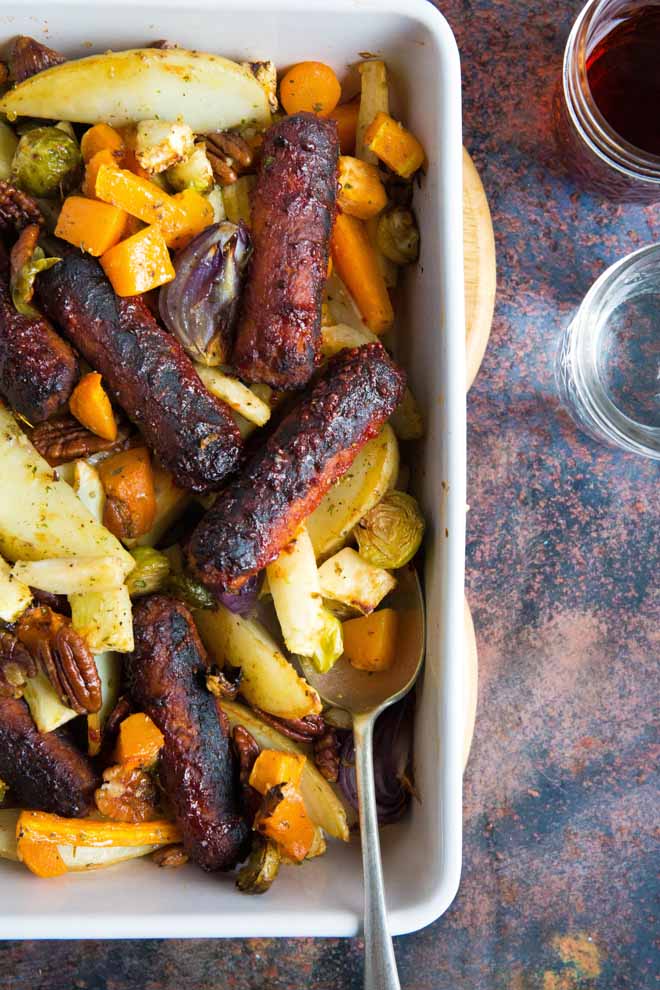 This tray bake is family friendly total comfort food - all cooked in one dish and perfectly adaptable to your own favourite sausages and veg! #traybake #sheetpanmeal #vegansausages #familymeal #roastveg | Recipe on thecookandhim.com