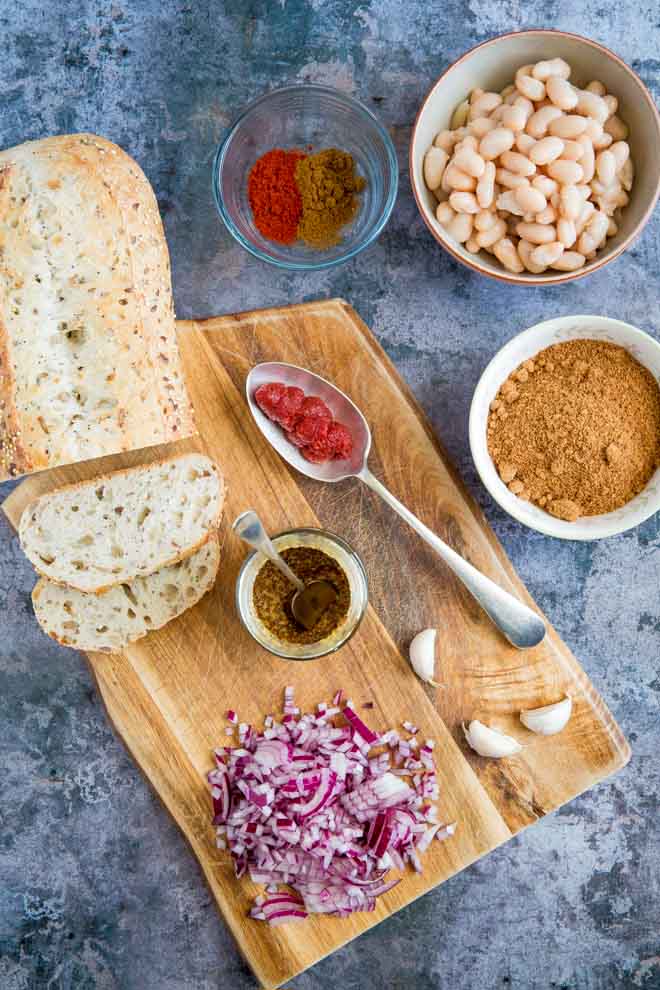 Both sweet and savoury with a spicy kick, these homemade baked beans are made with just a few store cupboard ingredients but are so versatile and absolutely packed with flavour! #bakedbeans #veganrecipes #spicybeans #comfortfood | Recipe on thecookandhim.com