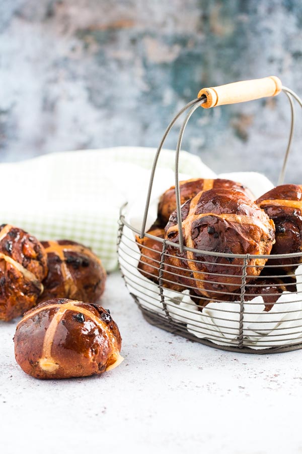 Celebrate Easter in style with these heavenly Double Chocolate and Orange Hot Cross Buns! Packed with zesty orange, chocolate chunks and soft apricots! #veganeaster #easterrecipes #veganchocolate #veganbaking #hotcrossbuns | Recipe on thecookandhim.com