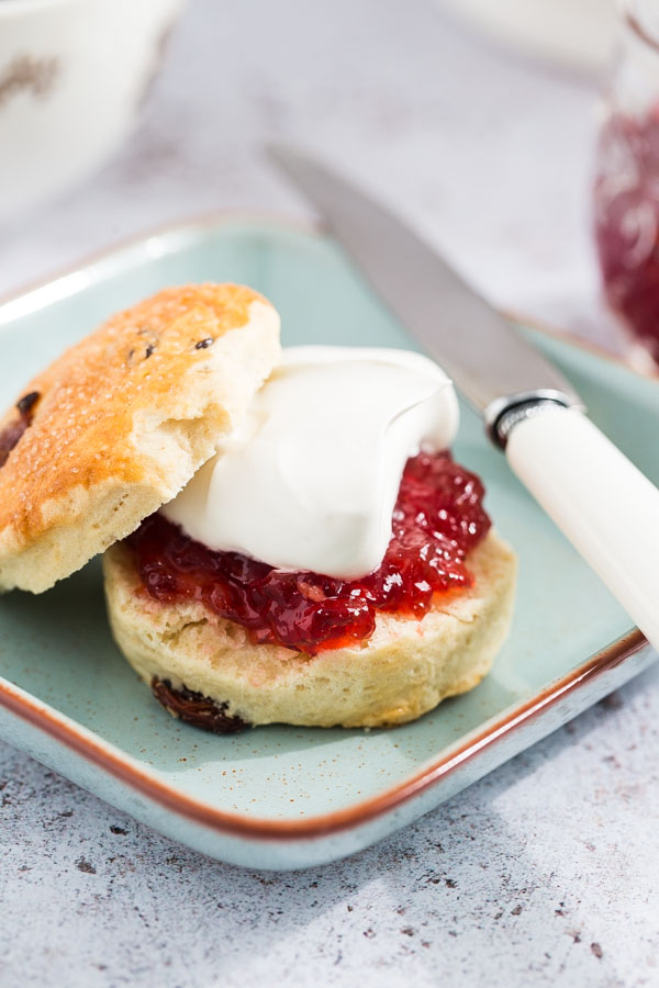 These vegan scones are just as easy and delicious as traditional ones with soft fluffy centres and sweet golden tops! Serve with a super easy homemade jam and vegan cream for the perfect vegan afternoon treat! #veganscones #vegansconerecipe #veganrecipes #veganbaking #afternoontea | Recipe on thecookandhim.com