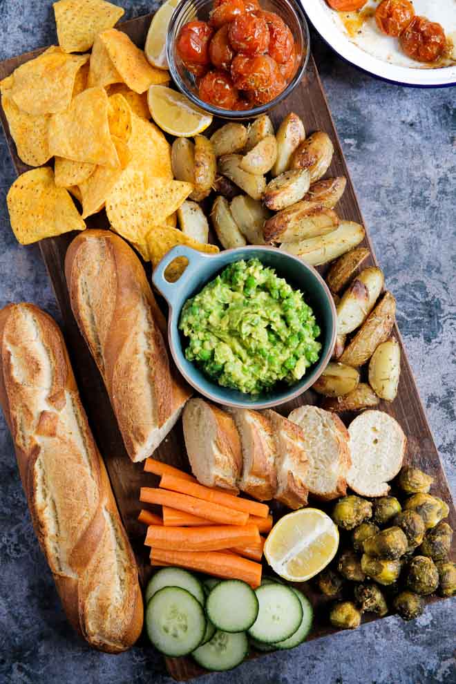 Bright petit pois and fresh herbs liven up a traditional guacamole, giving it a lovely sweetness and chunky texture, perfect for dipping and spreading! #healthyfats #mexicanfood #guacamole #avocadorecipes #avocado #avocadodip #veganguacamole #dip | Recipe on thecookandhim.com
