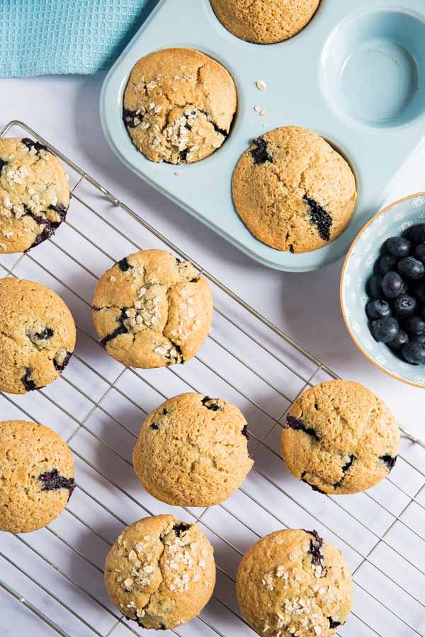 These vegan blueberry muffins are deliciously light and dangerously moreish. We can't just stop at one! They're also ridiculously easy to make too! #veganmuffins #blueberrymuffins #veganrecipes #muffinrecipe #blueberrymuffinrecipe #veganbaking | Recipe on thecookandhim.com