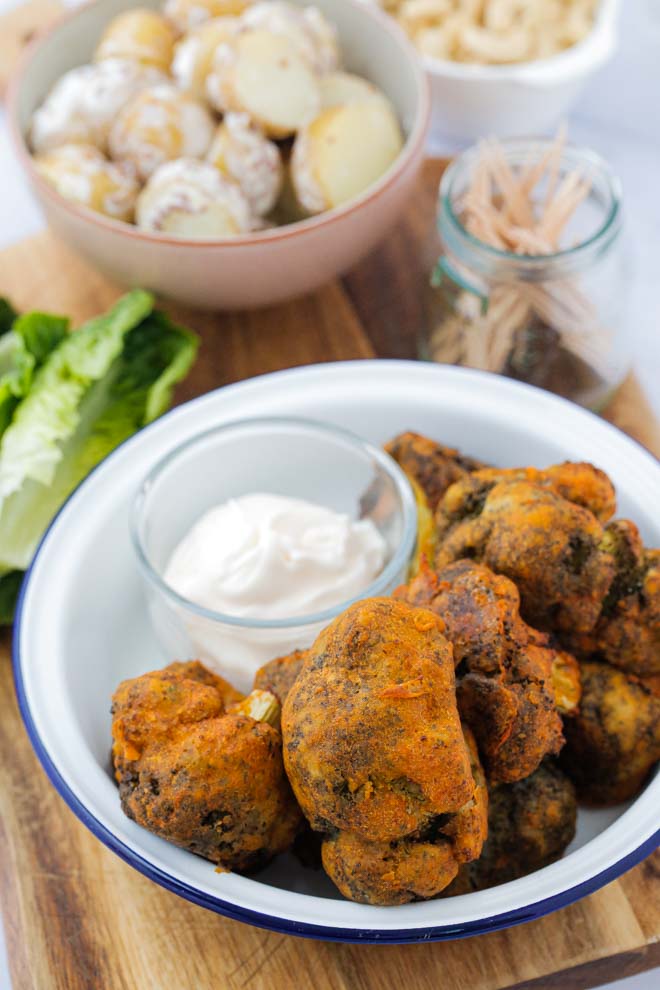 A healthier snack, main dish or side these buffalo broccoli bites are full of bold, spicy flavour. Crisp outside and tender inside, serve with a cooling dip for a family favourite! #buffalo #veganrecipes #buffalobroccoli #healthysnacks #plantbased #veganwings | Recipe on thecookandhim.com