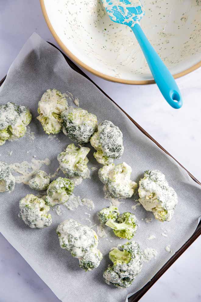 A healthier snack, main dish or side these buffalo broccoli bites are full of bold, spicy flavour. Crisp outside and tender inside, serve with a cooling dip for a family favourite! #buffalo #veganrecipes #buffalobroccoli #healthysnacks #plantbased #veganwings | Recipe on thecookandhim.com