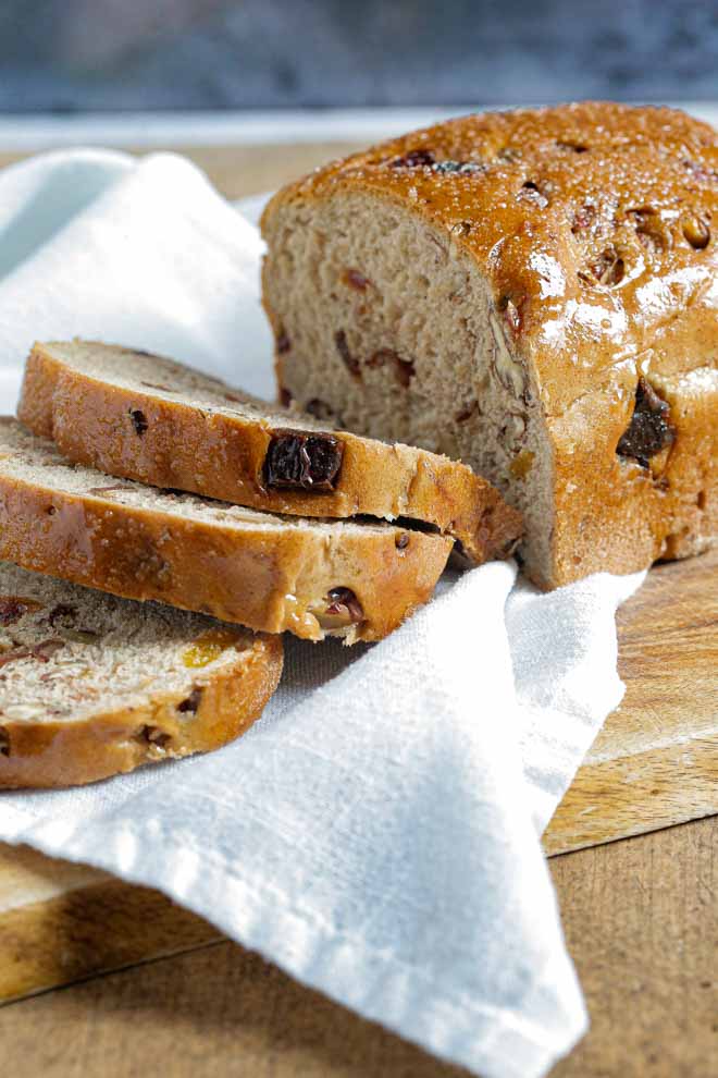 Get the kettle on and the tea cosies out because this spiced fruit loaf makes a wonderful breakfast or afternoon treat, slathered in butter and enjoyed fresh and warm or toasted the next day! #fruitloaf #fruitbread #homemadebread #veganbread #spicedbread #christmasbread | Recipe on the cookandhim.com