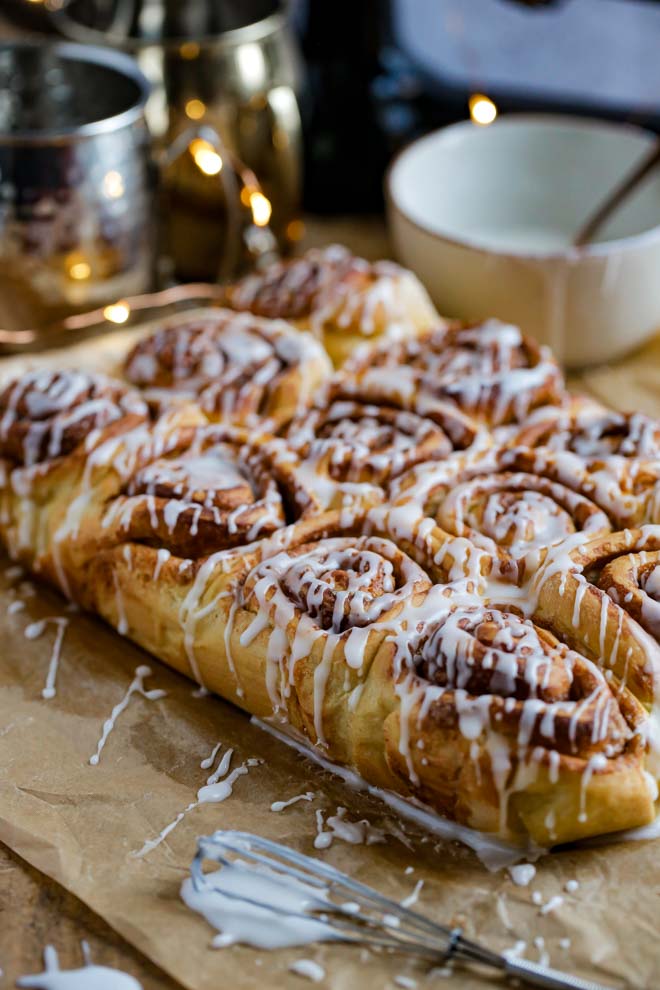Pumpkin Spice Cinnamon Rolls are the perfect cold day treat made with real pumpkin and fragrant spice! They’re soft and sticky and topped with a very simple drizzled icing #psl #cinnamon rolls #pumpkinspice #cinnamonbuns #thecookandhim #icedbuns #vegancinnamonswirls #stickybuns | Recipe on thecookandhim.com