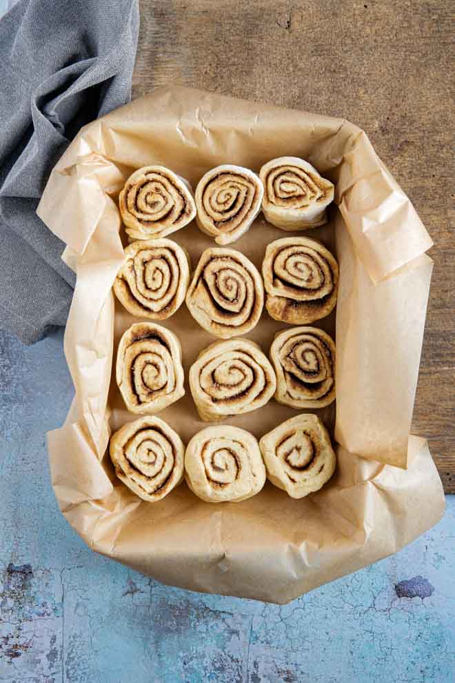 Pumpkin Spice Cinnamon Rolls are the perfect cold day treat made with real pumpkin and fragrant spice! They’re soft and sticky and topped with a very simple drizzled icing #psl #cinnamon rolls #pumpkinspice #cinnamonbuns #thecookandhim #icedbuns #vegancinnamonswirls #stickybuns | Recipe on thecookandhim.com