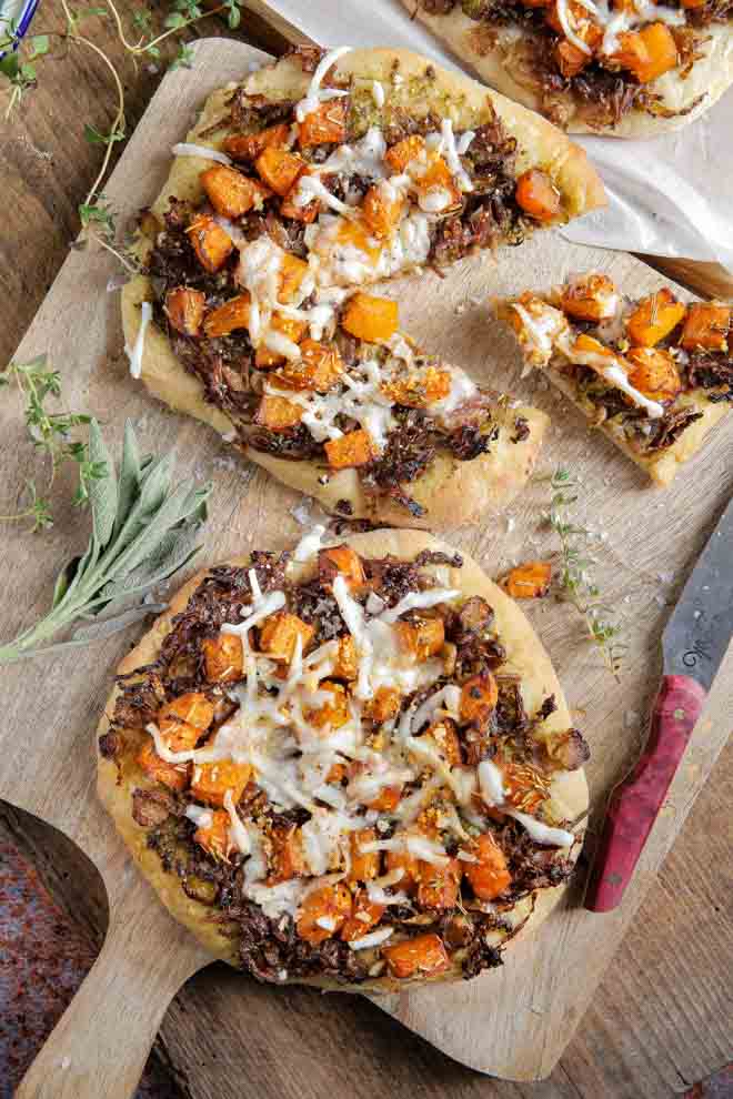 Simple but delicious this autumn harvest pizza is full of all the best seasonal flavours, herbs and gentle spices. Top with tangy vegan cheese for a comfort food favourite! #veganpizza #pizza #vegancheese #plantbasedpizza #dairyfreepizza #meatfreepizza | Recipe on thecookandhim.com
