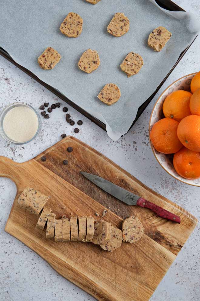 Vegan slice and bake chocolate orange shortbread cookies are perfect little bitesize pieces of nutty, spicy cookie heaven! So simple to make, no rolling and just a few ingredients! #vegancookies #veganshortbread #sliceandbake #chocolateorange #shortbreadcookies #shortbread | Recipe on thecookandhim.com