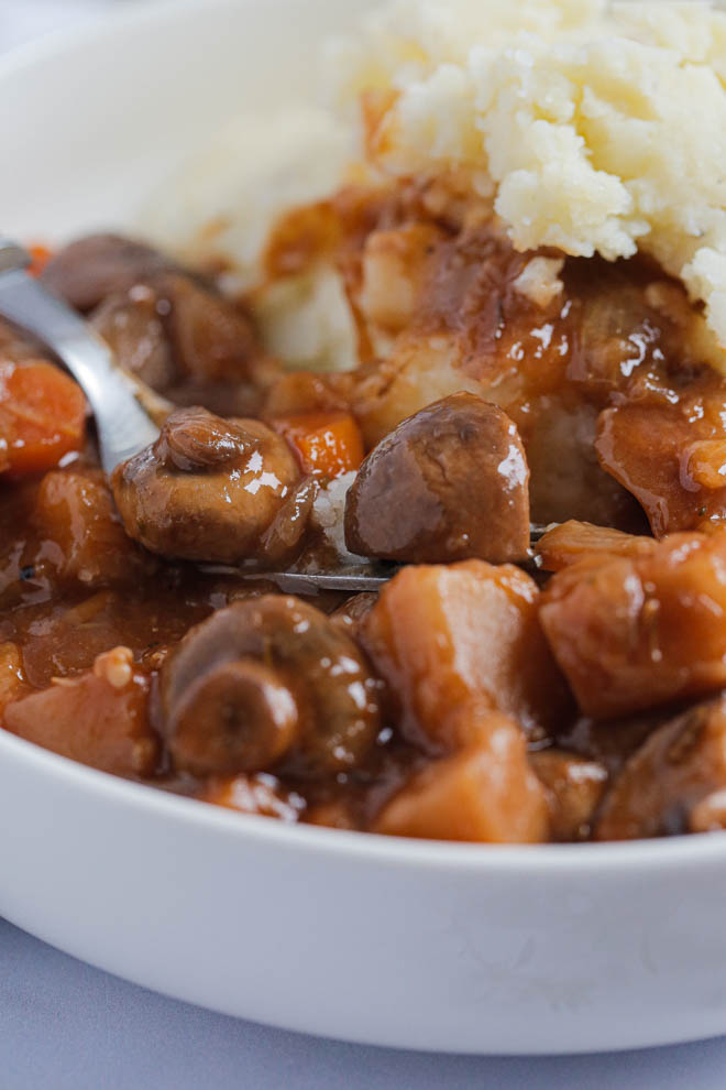 For a healthy, hearty and easy family meal this vegan mushroom bourguignon is filling, comforting and guaranteed to warm you up from the inside out! Full of veggies and herbs in a rich red wine sauce it's made in an Instant Pot for an easy weeknight meal #mushrooms #vegan #bourguignon #mushroombourguignon #veganstew #veganinstantpot #instantpot #slowcooker #veganslowcooker | Recipe on thecookandhim.com