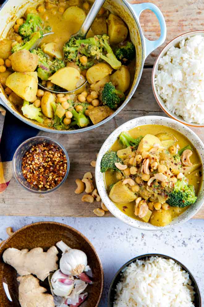 Try this hearty, spicy, easy chickpea and potato curry full of warm, rich flavours for a wholesome midweek meal for the family! Much cheaper and just as quick as takeout! #vegancurry #vegancurryrecipes #chickpeacurryrecipe #chickpeapotatocurryrecipe #potatocurry #vegetablecurry #coconutmilk #garbanzobeans #masala #turmeric | Recipe on thecookandhim.com